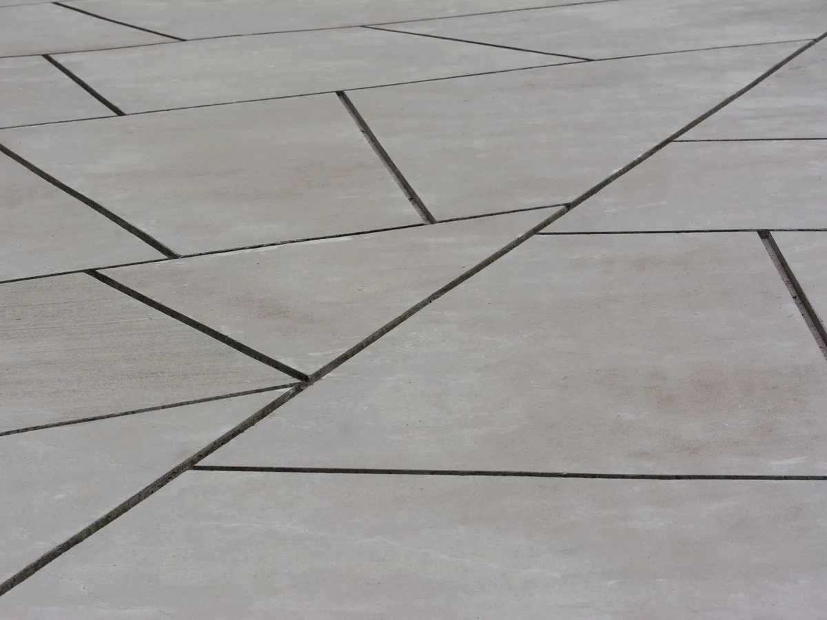 A poured concrete slab with saw cut control joints